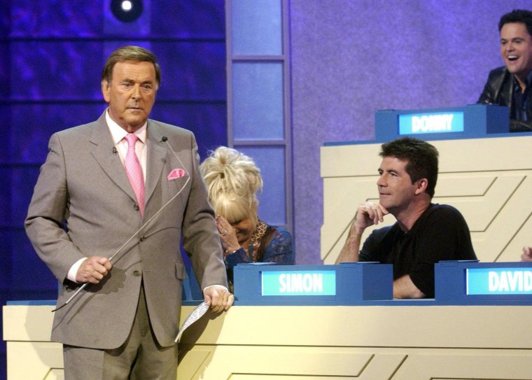 BBC handout photo of Terry Wogan with Simon Cowell and Barbara Windsor for Blankety Blank on Children in Need night 2004, Friday 19th November 2004. See PA story SHOWBIZ Children. PA Photo: BBC Warning: Use of this copyright image is subject to Terms of Use of BBC Digital Picture Service. In particular, this image may only be used during the publicity period for the purpose of publicising BBC Children In Need 2004 and provided BBC Children In Need is credited. Any use of this image on the internet or for any other purpose whatsoever, including advertising or other commercial uses, requires the prior written approval of the BBC.