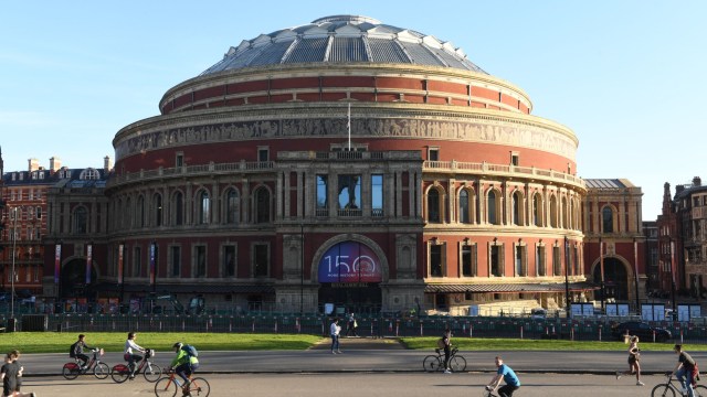 Article thumbnail: LONDON, ENGLAND - MARCH 29: Cyclists ride by as the text "150 More History To Make" is displayed outside of the Royal Albert Hall on March 29, 2021 in London, England. Monday 29th March 2021 marks the 150th anniversary of the iconic music venue. (Photo by Stuart C. Wilson/Getty Images)