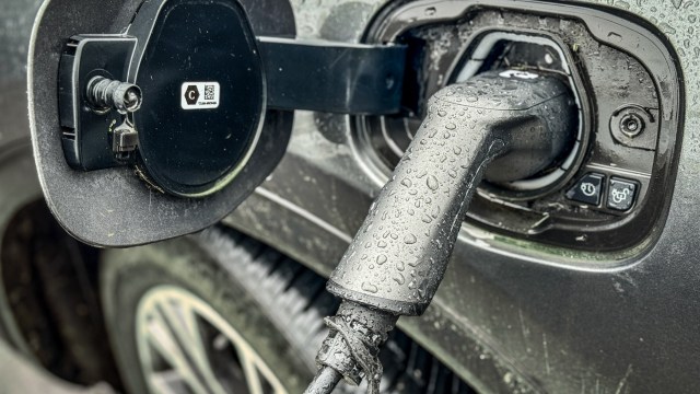 Article thumbnail: BATH, UNITED KINGDOM - FEBRUARY 25: A electric car is charged by a wall charger in a city centre car park, on February 25, 2024 in Bath, England. The government's commitment to reducing future Co2 carbon emissions will mean many more motorists will need to switch from petrol and diesel powered cars to electric (EV) driven ones. However there are also fears that the charging network in the UK is not yet fit to deal with the enormous demand more EVs on the road would place on it.(Photo by Matt Cardy/Getty Images)