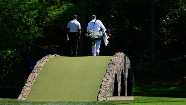 Article thumbnail: Tiger Woods walks over the Ben Hogan Bridge on the 12th hole during third round at the Masters golf tournament at Augusta National Golf Club Saturday, April 13, 2024, in Augusta, Ga. (AP Photo/Matt Slocum)