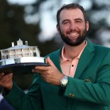 Article thumbnail: Golf - The Masters - Augusta National Golf Club, Augusta, Georgia, U.S. - April 14, 2024 Scottie Scheffler of the U.S. celebrates with his green jacket and the trophy after winning The Masters REUTERS/Mike Segar TPX IMAGES OF THE DAY