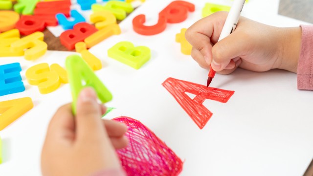 Article thumbnail: Young child practicing writing English letters