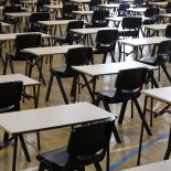 Article thumbnail: Rows or plain single student desks or table arranged in order for major school examinations or exams.