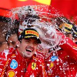 Article thumbnail: Leclerc is doused in champagne by Ferrari teammate Sainz (Photo: Getty)