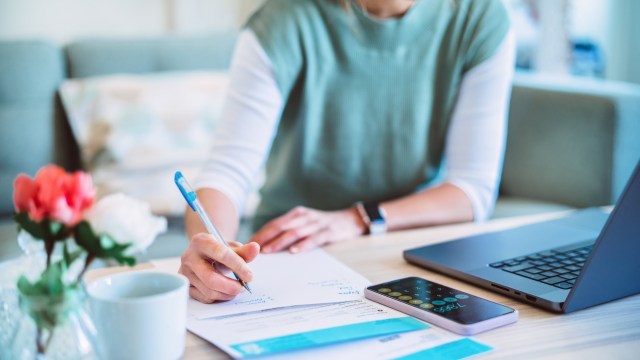 Article thumbnail: Young Asian women managing home finance using laptop & smartphone. She is working with household utility bill and calculating expenses at home.