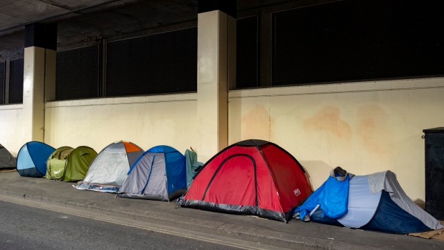 Article thumbnail: Homeless persons tents pitched in line on the pavement in an underpass near Blackfriars in the City of London on 8th April 2024 in London, United Kingdom. (photo by Mike Kemp/In Pictures via Getty Images)