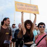 Article thumbnail: A demonstrator holds up a banner as people protest against mass tourism in Barcelona, Spain, July 6, 2024. The Catalan capital received more than 12 million tourists in 2023 and expects more in 2024. REUTERS/Bruna Casas