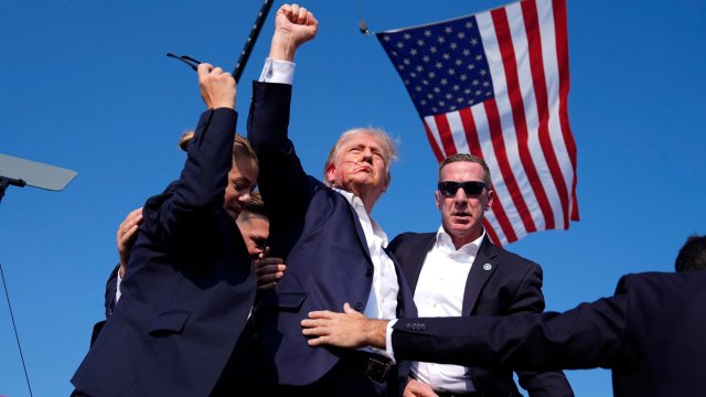 Republican presidential candidate former President Donald Trump gestures as he is surrounded by U.S. Secret Service agents as he leaves the stage at a campaign rally, Saturday, July 13, 2024, in Butler, Pa. (AP Photo/Evan Vucci)