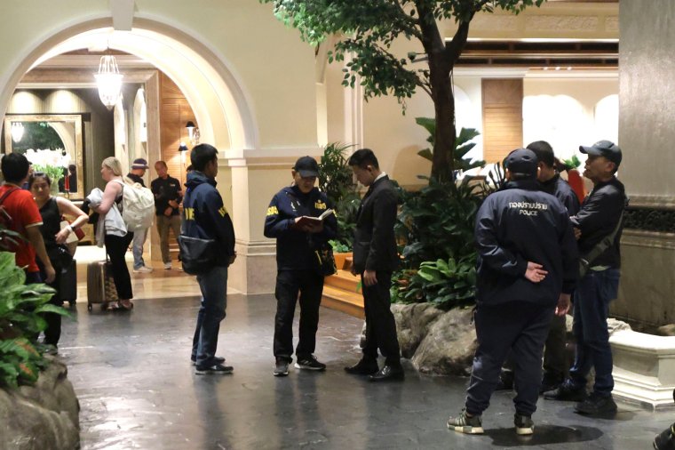 Police officers talk to a staff member at the Grand Hyatt Erawan Hotel in Bangkok, Thailand, Tuesday, July 16, 2024. Police said a number of people were found dead Tuesday in the luxury hotel in downtown Bangkok and poisoning is suspected. (AP Photo/Chatkla Samnaingjam)