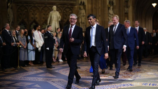 Britain's Prime Minister Keir Starmer (L) and Britain's Conservative Party opposition leader Rishi Sunak (R) speak together as they process through the Central Lobby during the State Opening of Parliament at the Houses of Parliament, in London, on July 17, 2024. (Photo by Dan Kitwood / POOL / AFP) (Photo by DAN KITWOOD/POOL/AFP via Getty Images)