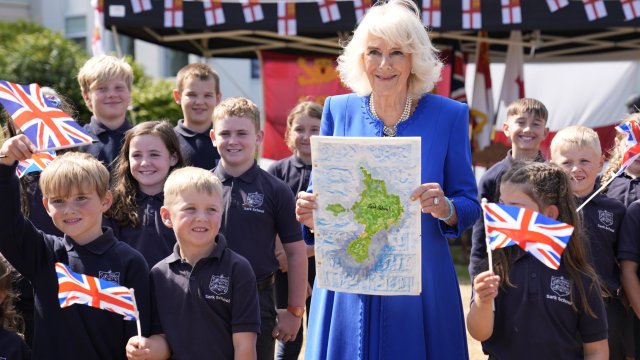 ST PETER PORT, GUERNSEY - JULY 16: Queen Camilla poses with local school children during a visit to Les Cotils at L'Hyvreuse, during an official visit to Guernsey on July 16, 2024 in St Peter Port, Guernsey. (Photo by Andrew Matthews - WPA Pool/Getty Images)