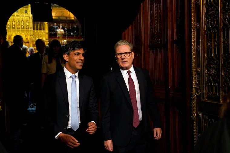 Prime Minister Sir Keir Starmer (right) and former prime Minister Rishi Sunak (left) talk as they walk towards the House of Lords during House of Lords Chamber during the State Opening of Parliament in the House of Lords at the Palace of Westminster in London. Picture date: Wednesday July 17, 2024. PA Photo. See PA story POLITICS Speech. Photo credit should read: Alberto Pezzali/PA Wire