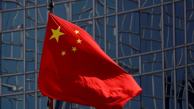 Article thumbnail: FILE PHOTO: The Chinese national flag is seen in Beijing, China April 29, 2020. REUTERS/Thomas Peter/File Photo